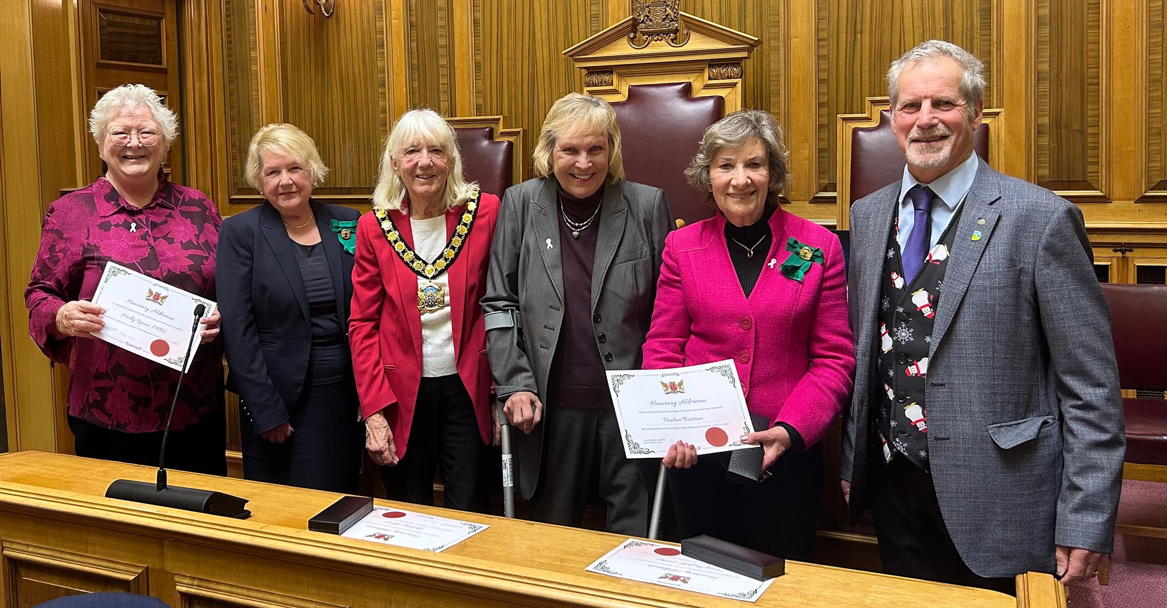 from left to right is Molly Rennie, Val Pothecary (previous Chair), Stella Jones (current Chair), Mary Penfold, Pauline Batstone, Les Fry (current vice Chair)