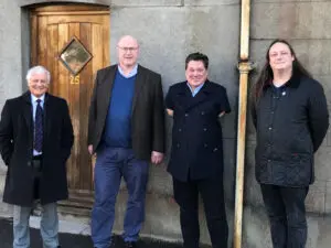 Mike Lewis and Adam Perkins of the Blandford Freemasons with Cllr Graham Carr-Jones, Portfolio Holder for Housing and Cllr Nocturin Lacey-Clarke, Blandford Ward, outside the new home in West Street.