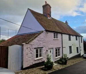 A two-story house with white and light pink walls